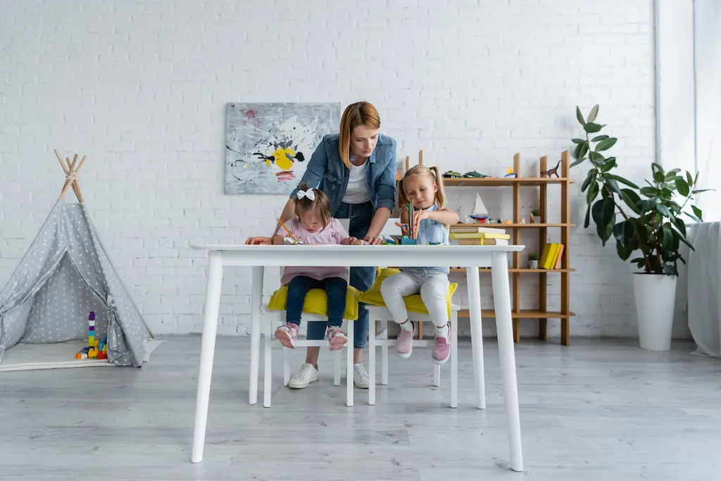 a childcare provider teaching two children as part of lesson planning