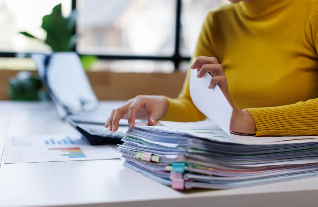 an office administrator working using paperwork to manage school systems